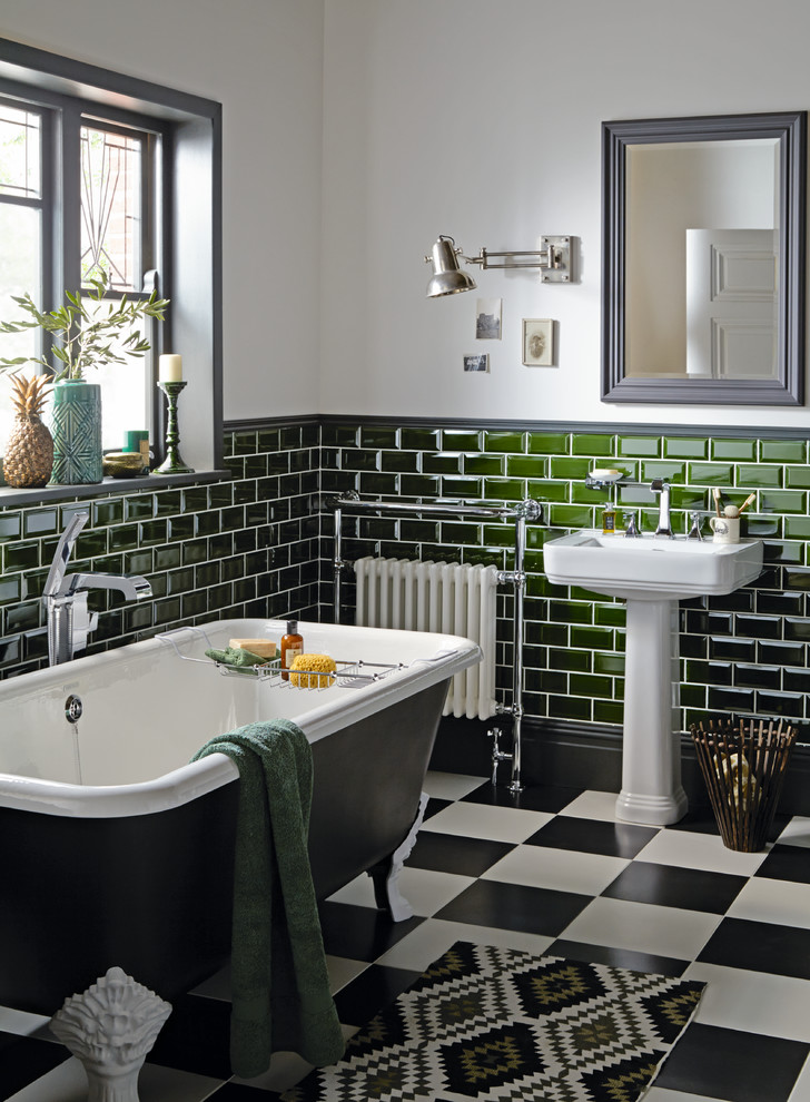 Photo of a mid-sized traditional bathroom in West Midlands with a claw-foot tub, green tile, subway tile, grey walls, a console sink and multi-coloured floor.