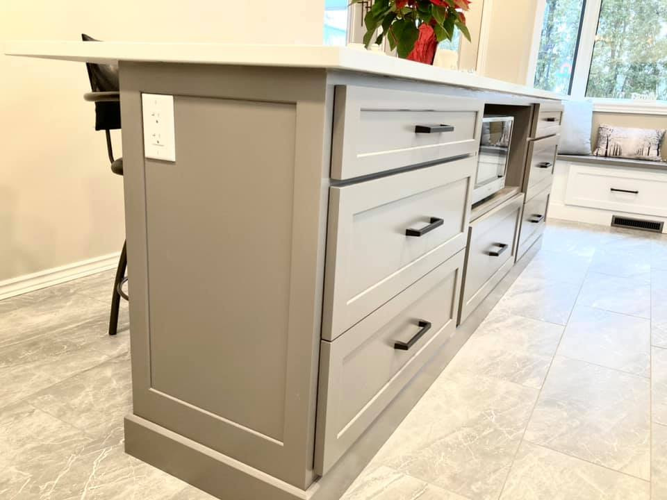 Example of a mid-sized transitional galley ceramic tile and gray floor enclosed kitchen design with a double-bowl sink, shaker cabinets, white cabinets, quartz countertops, gray backsplash, ceramic backsplash, stainless steel appliances, an island and white countertops