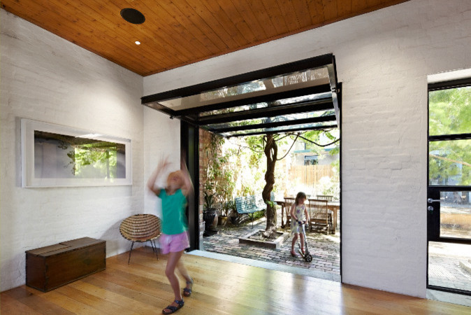 Contemporary open concept living room in Melbourne with white walls and medium hardwood floors.