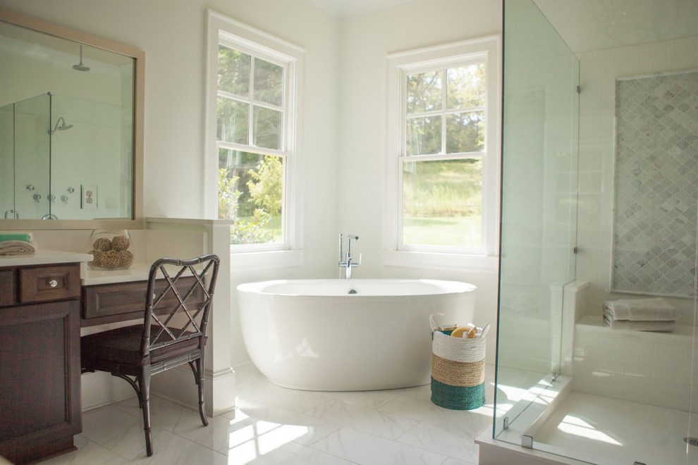This is an example of a traditional bathroom in Atlanta with dark wood cabinets, a freestanding tub, white walls, medium hardwood floors and white tile.