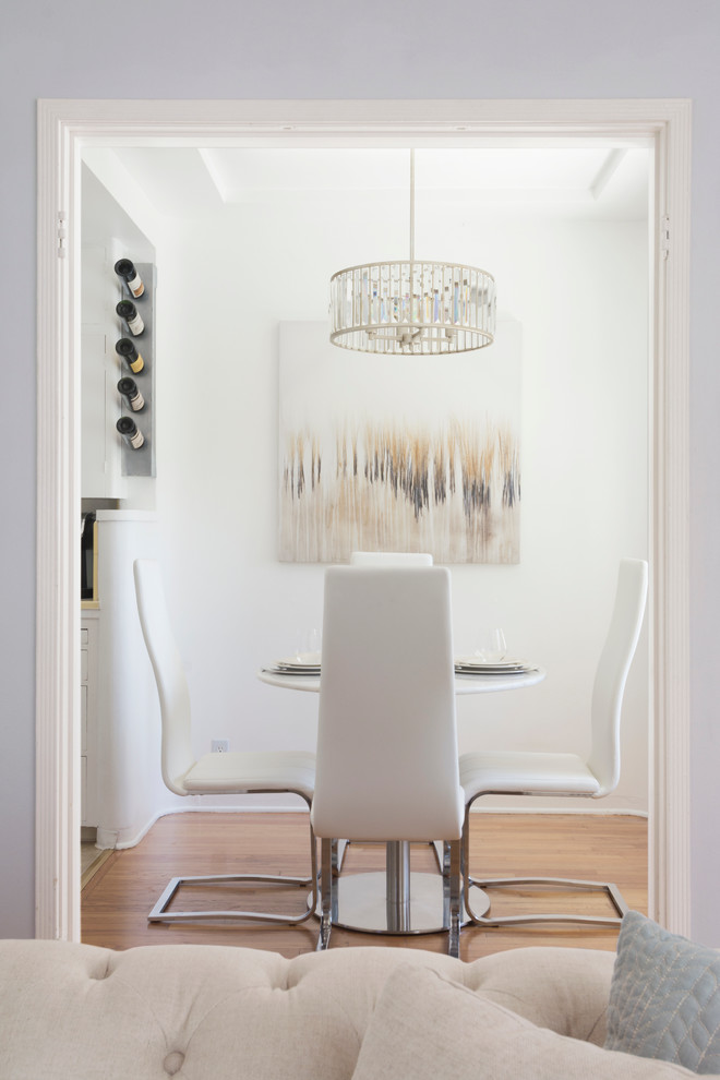 Contemporary dining room in Los Angeles with white walls, medium hardwood floors and no fireplace.