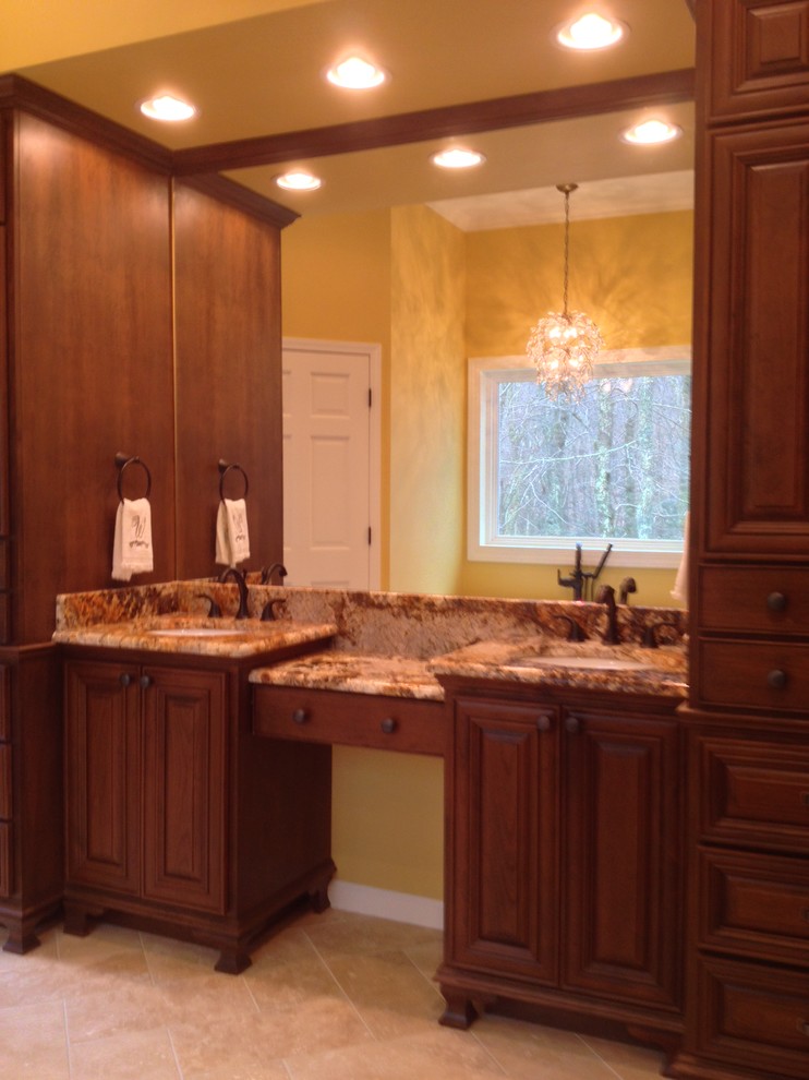 Large traditional master bathroom in Charlotte with an undermount sink, furniture-like cabinets, medium wood cabinets, granite benchtops, a freestanding tub, an open shower, a one-piece toilet, beige tile, stone tile, beige walls and travertine floors.