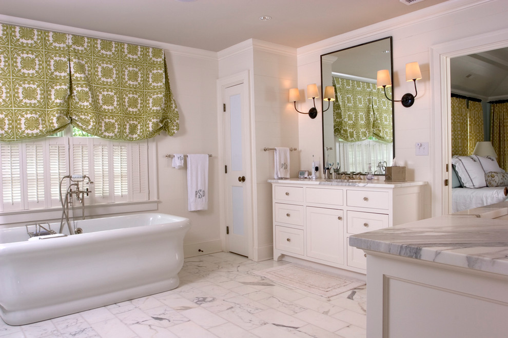 Traditional bathroom in Charlotte with a freestanding tub and marble benchtops.
