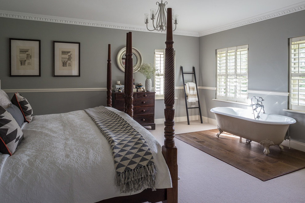 Photo of a mid-sized traditional bedroom in London with grey walls, carpet and beige floor.