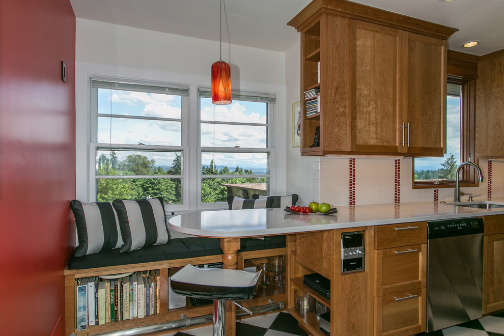 Mid-sized country galley eat-in kitchen in Portland with an undermount sink, shaker cabinets, medium wood cabinets, quartz benchtops, white splashback, ceramic splashback, stainless steel appliances, porcelain floors and no island.