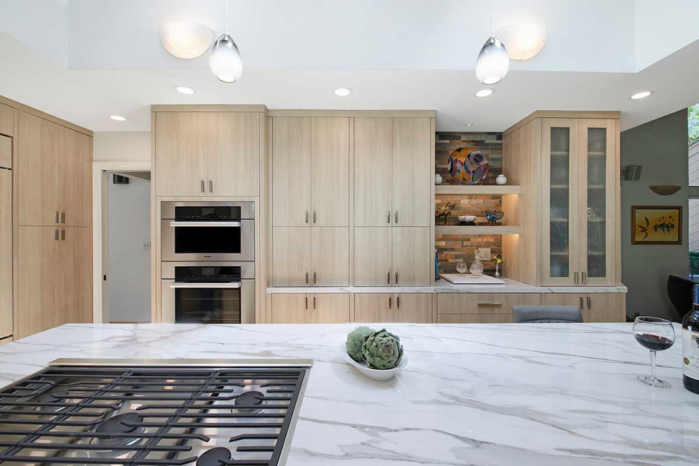 Design ideas for a large contemporary l-shaped eat-in kitchen in San Francisco with an undermount sink, flat-panel cabinets, light wood cabinets, multi-coloured splashback, stone tile splashback, panelled appliances, plywood floors, with island, beige floor, white benchtop and vaulted.