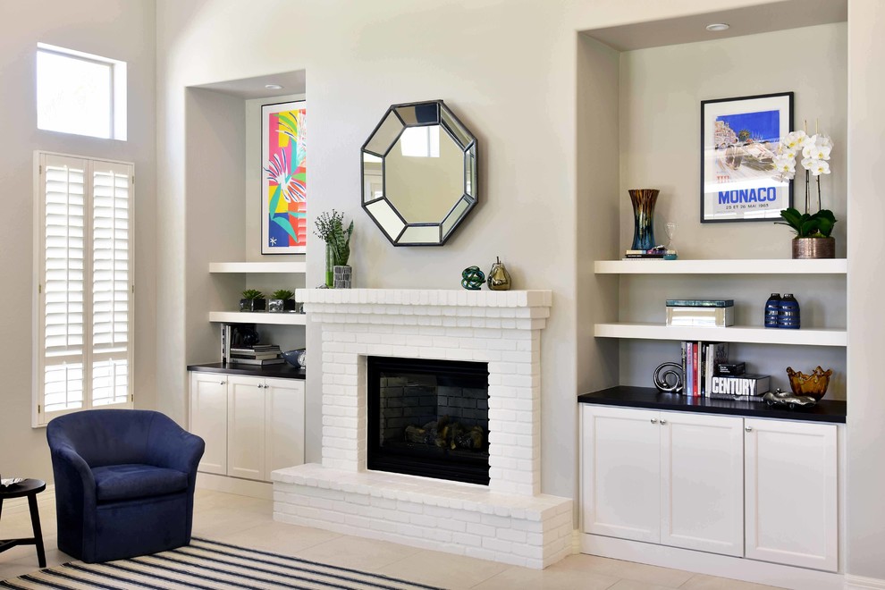 Inspiration for a mid-sized transitional open concept family room in Phoenix with beige walls, porcelain floors, a standard fireplace, a brick fireplace surround, no tv and beige floor.
