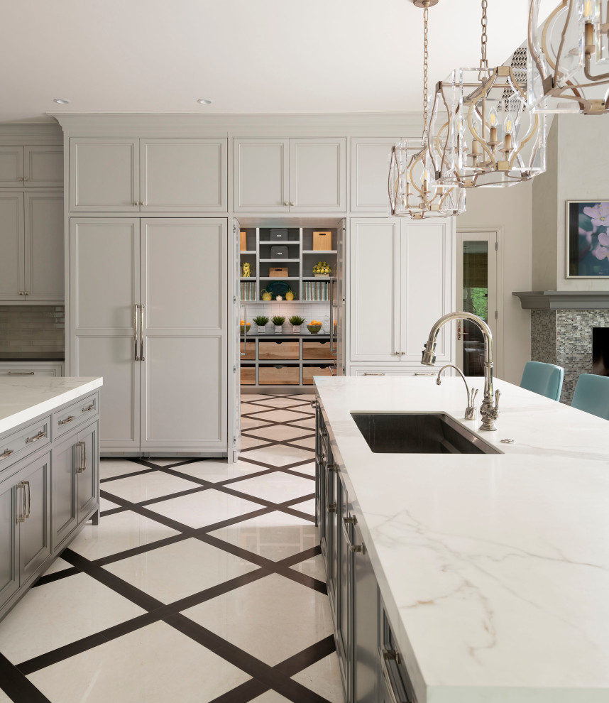 Design ideas for an expansive transitional kitchen in Dallas with an undermount sink, flat-panel cabinets, grey cabinets, white splashback, marble splashback, panelled appliances, marble floors, multiple islands, white floor and white benchtop.