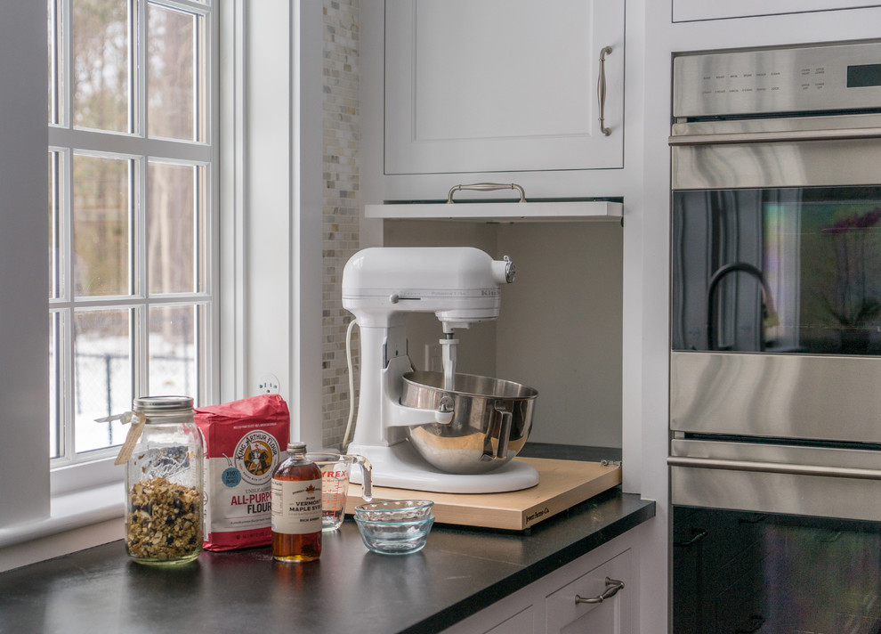 Kitchen - mid-sized transitional l-shaped dark wood floor and brown floor kitchen idea in Boston with an integrated sink, recessed-panel cabinets, white cabinets, soapstone countertops, multicolored backsplash, porcelain backsplash, stainless steel appliances and an island
