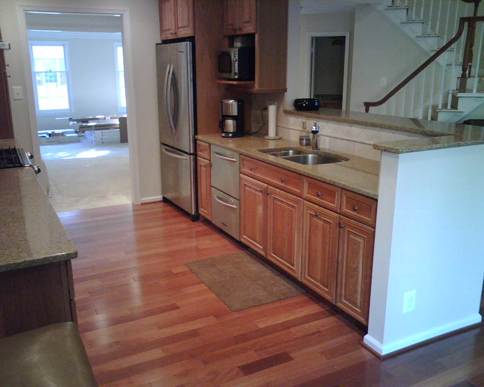 Inspiration for a medium tone wood floor kitchen remodel in DC Metro with medium tone wood cabinets and stainless steel appliances