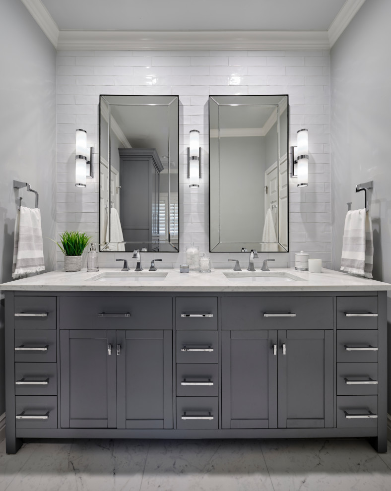 Bathroom - mid-sized transitional kids' white tile and ceramic tile porcelain tile, gray floor and double-sink bathroom idea in Austin with furniture-like cabinets, gray cabinets, a two-piece toilet, gray walls, an undermount sink, quartz countertops, white countertops and a freestanding vanity