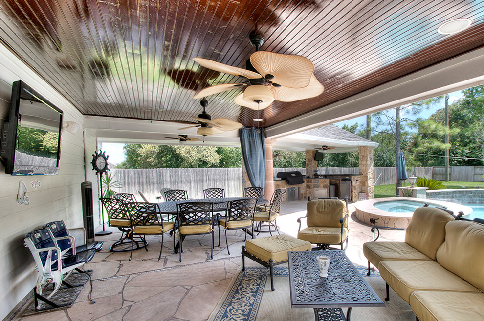 Design ideas for a traditional patio in Houston with natural stone pavers.
