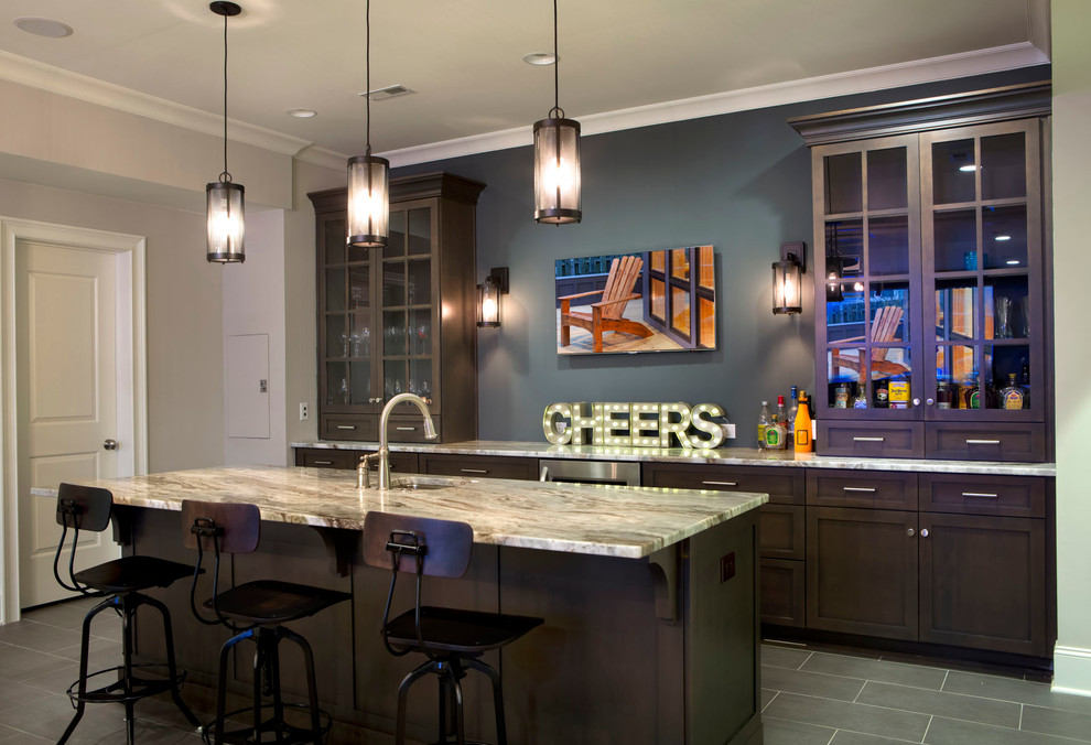 Design ideas for a traditional seated home bar in Charlotte with an undermount sink, glass-front cabinets and dark wood cabinets.
