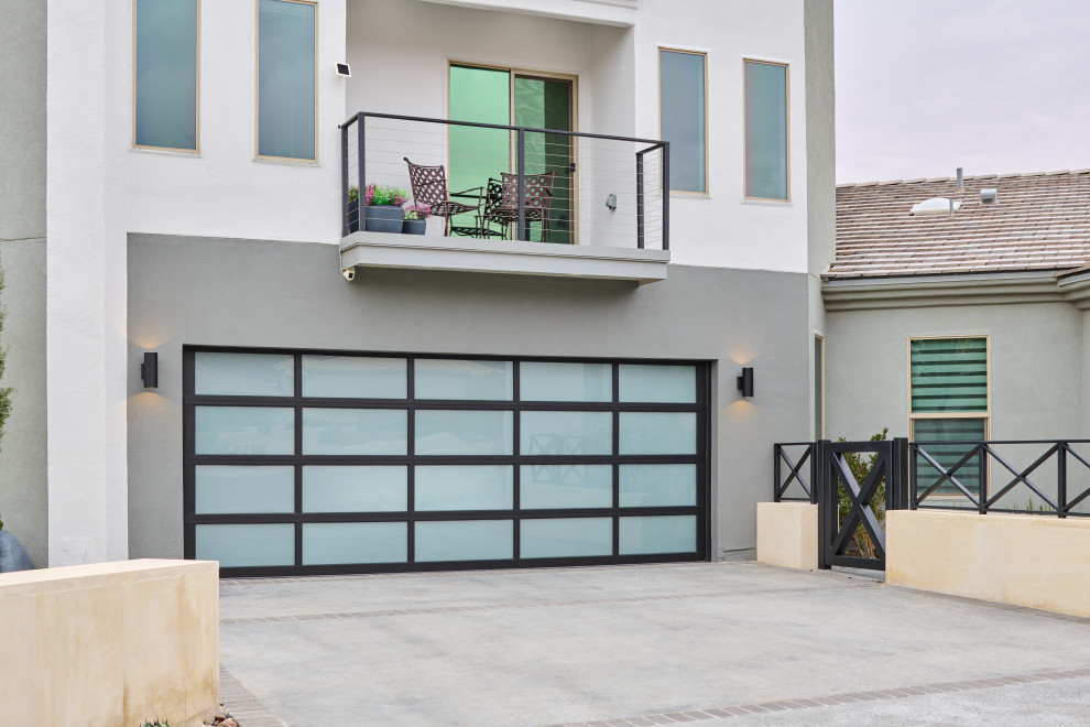 This is an example of a contemporary attached garage workshop in Other with four or more cars.