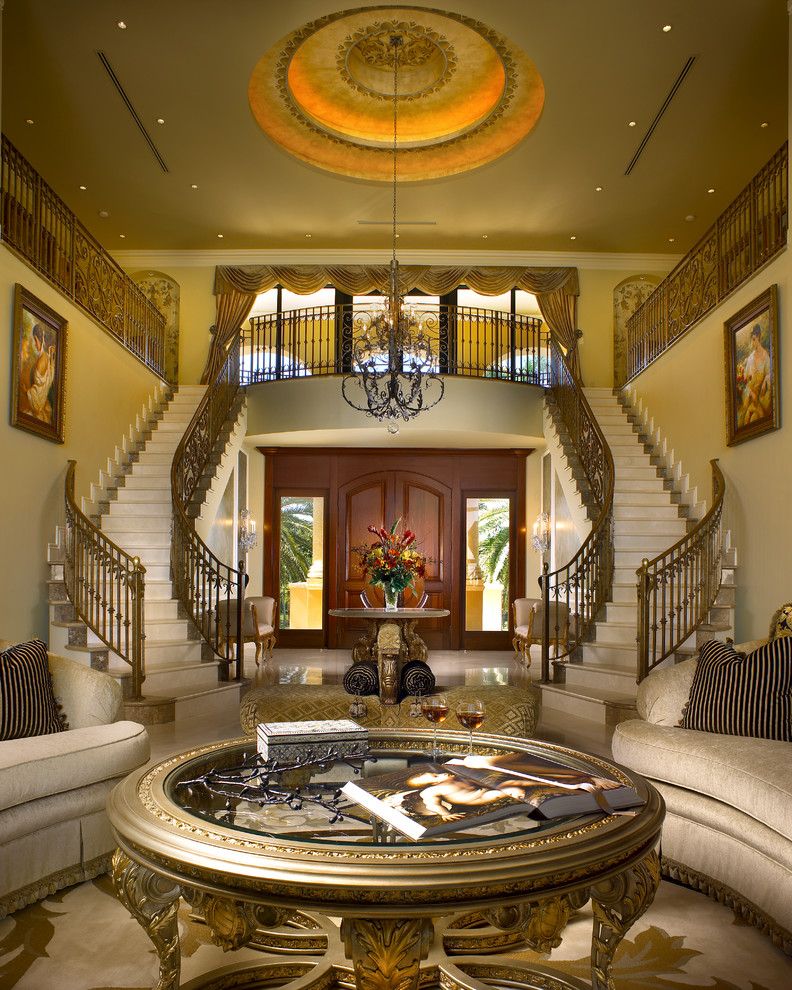 Inspiration for a large mediterranean marble curved staircase in Miami with marble risers and metal railing.