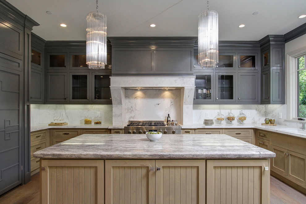 Traditional u-shaped separate kitchen in Los Angeles with an undermount sink, shaker cabinets, grey splashback, stone slab splashback, panelled appliances, medium hardwood floors, with island, brown floor and grey benchtop.