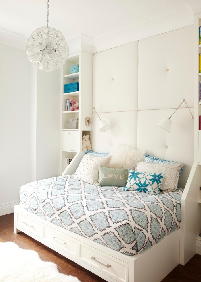 This is an example of a mid-sized transitional kids' bedroom for kids 4-10 years old and girls in New York with white walls and medium hardwood floors.