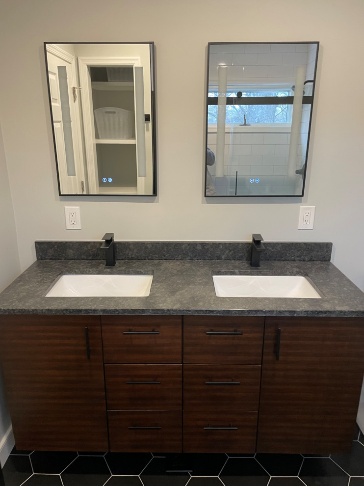 Photo of a medium sized modern ensuite bathroom in DC Metro with flat-panel cabinets, brown cabinets, an alcove shower, white tiles, porcelain tiles, grey walls, porcelain flooring, a submerged sink, granite worktops, black floors, a sliding door, black worktops, a shower bench, double sinks and a floating vanity unit.