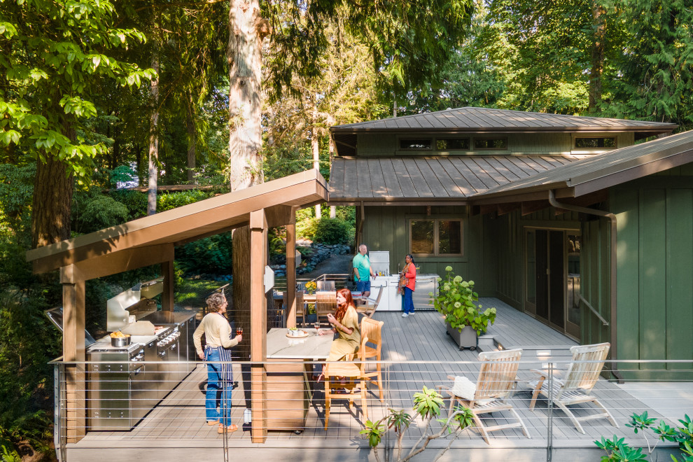 Outdoor kitchen deck - large contemporary backyard ground level metal railing outdoor kitchen deck idea in Seattle with a pergola
