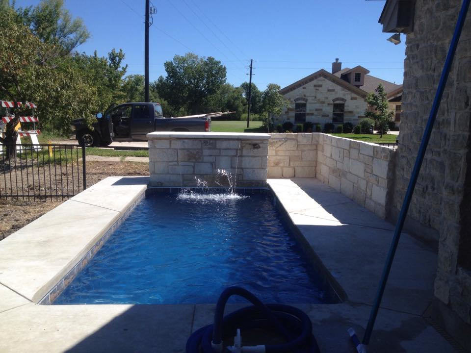Example of a small minimalist indoor rectangular indoor pool design in Austin with decking