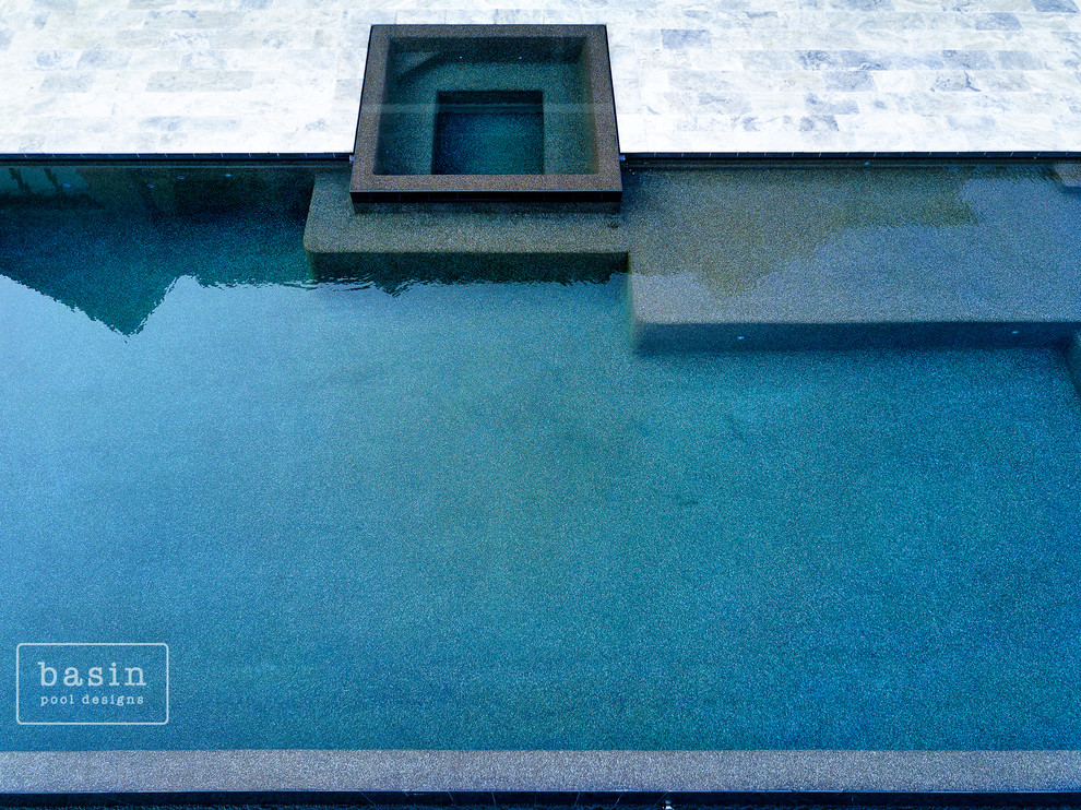 Inspiration for a large transitional backyard stone and custom-shaped infinity hot tub remodel in Nashville