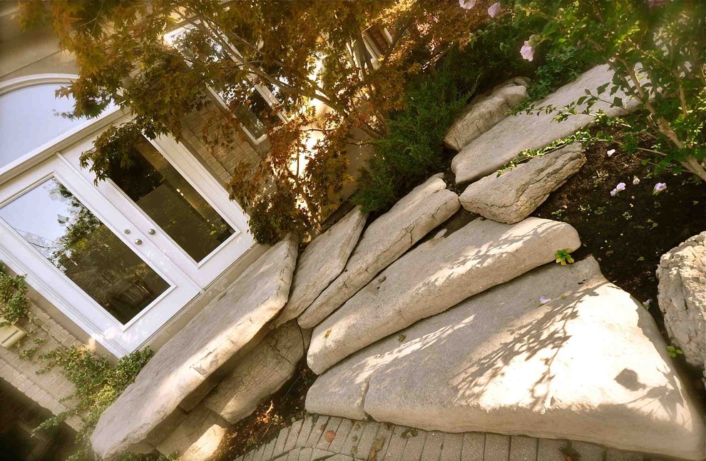 Photo of a mid-sized traditional front yard partial sun garden in Toronto with a garden path and natural stone pavers.