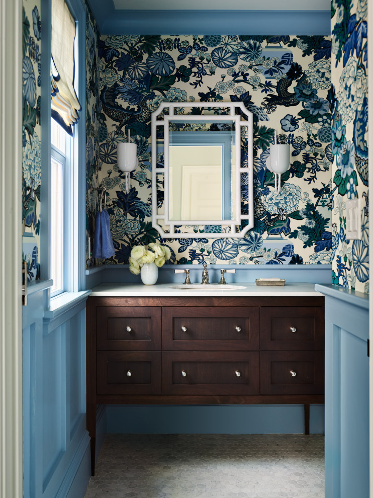 Powder room - transitional wallpaper powder room idea in Boston with dark wood cabinets, multicolored walls, white countertops and a built-in vanity