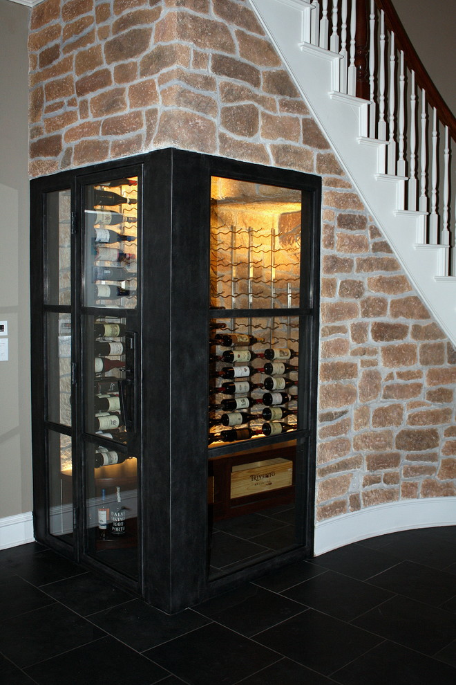 Photo of a small country wine cellar in Dallas with storage racks, dark hardwood floors and brown floor.