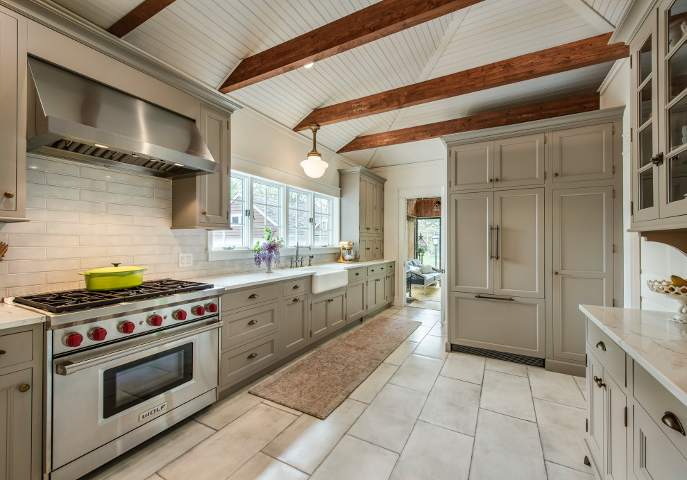 Design ideas for a mid-sized country separate kitchen in Philadelphia with a farmhouse sink, shaker cabinets, quartz benchtops, white splashback, subway tile splashback, stainless steel appliances, ceramic floors, white benchtop and vaulted.
