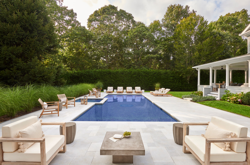 Design ideas for a large beach style side yard rectangular pool in New York with a hot tub and natural stone pavers.