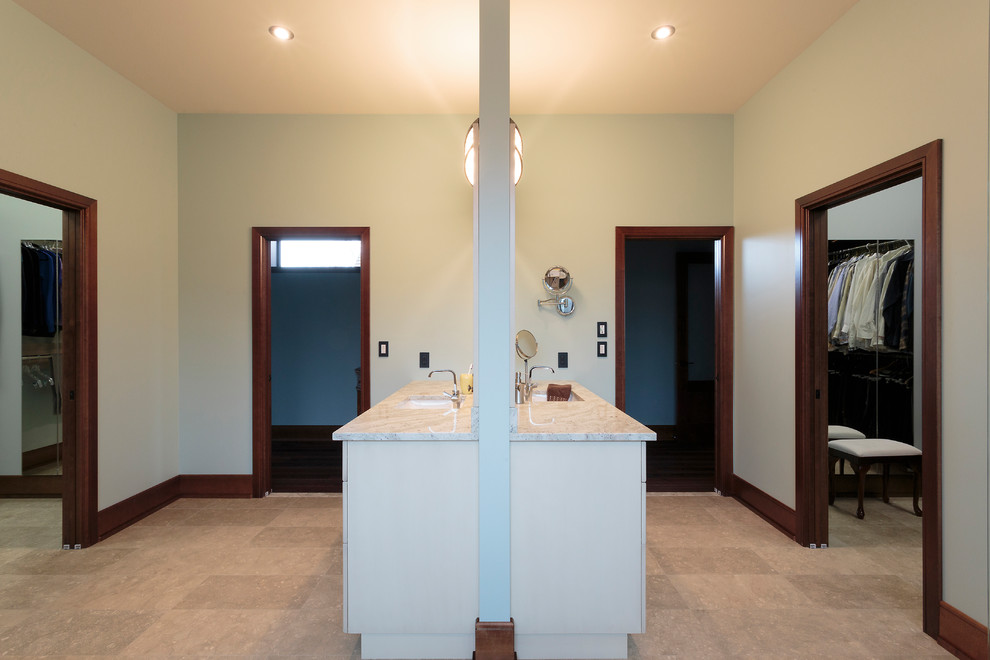 Photo of an expansive master bathroom in Other with beaded inset cabinets, white cabinets, a freestanding tub, a corner shower, a wall-mount toilet, beige tile, porcelain tile, blue walls, porcelain floors, an undermount sink, granite benchtops, beige floor, a hinged shower door and yellow benchtops.
