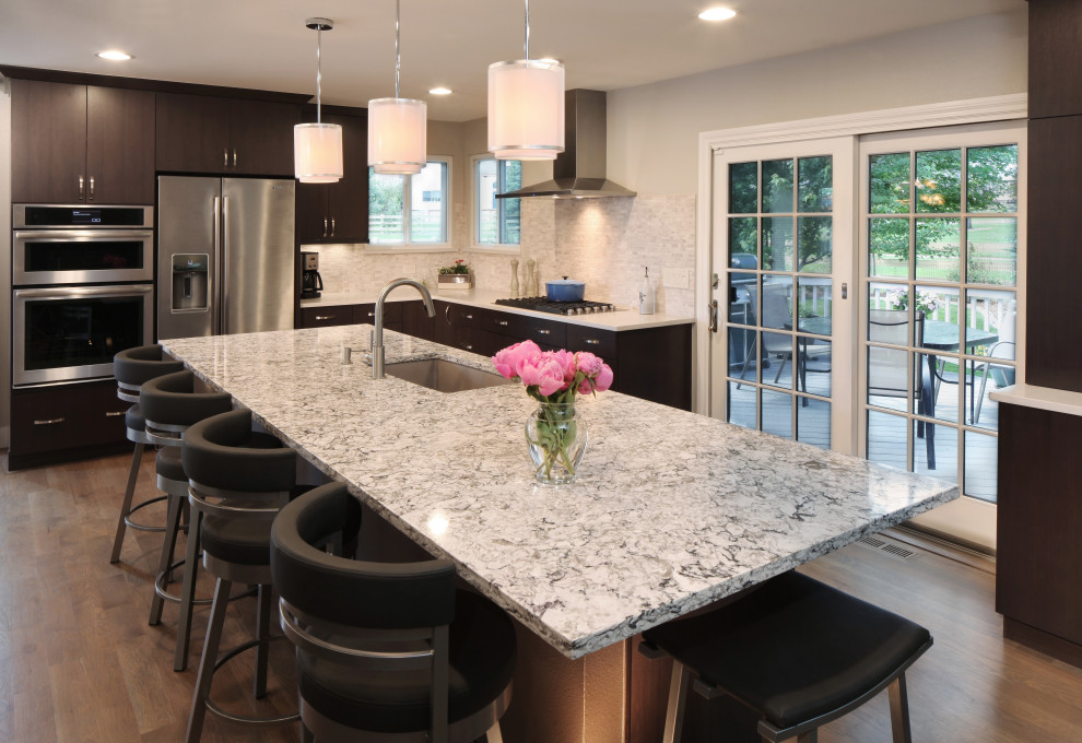 Minimalist kitchen photo with flat-panel cabinets, quartz countertops, an island and white countertops