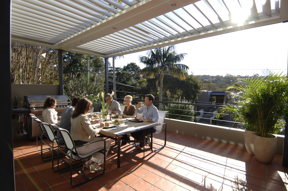 Design ideas for a contemporary courtyard patio in Sydney with tile and a pergola.