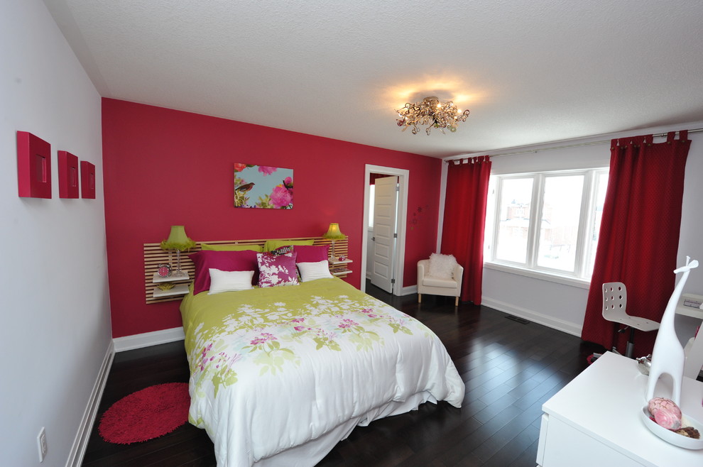 Photo of a mid-sized modern bedroom in Toronto with pink walls, dark hardwood floors, no fireplace and brown floor.