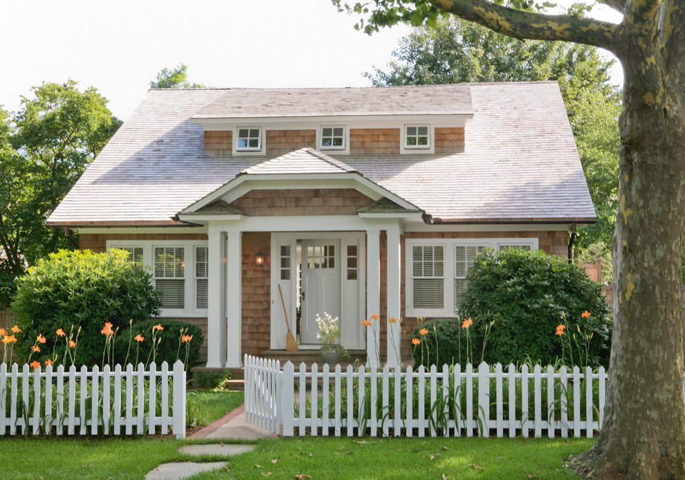 Design ideas for a traditional exterior in New York with wood siding and a clipped gable roof.
