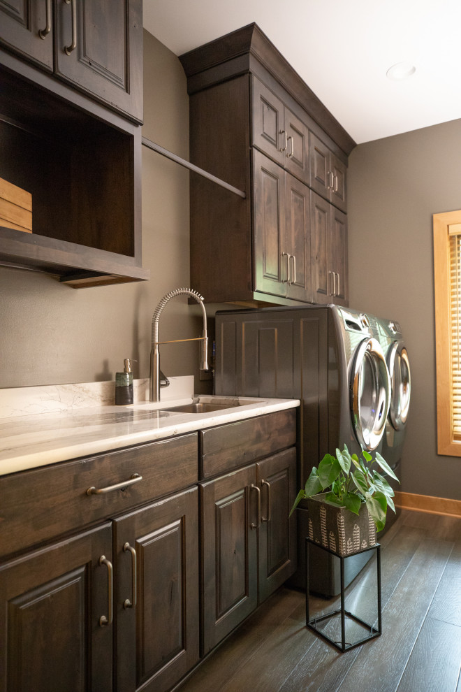 Inspiration for a mid-sized eclectic single-wall laundry cupboard in Milwaukee with an undermount sink, raised-panel cabinets, distressed cabinets, quartz benchtops, mosaic tile splashback, multi-coloured benchtop, brown walls, porcelain floors and a side-by-side washer and dryer.