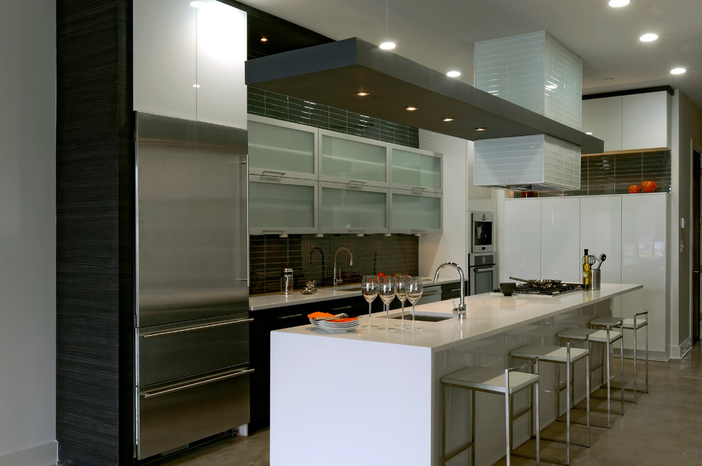 Mid-sized contemporary galley eat-in kitchen in DC Metro with an undermount sink, flat-panel cabinets, dark wood cabinets, grey splashback, stainless steel appliances, quartzite benchtops, glass tile splashback, concrete floors, with island and beige floor.
