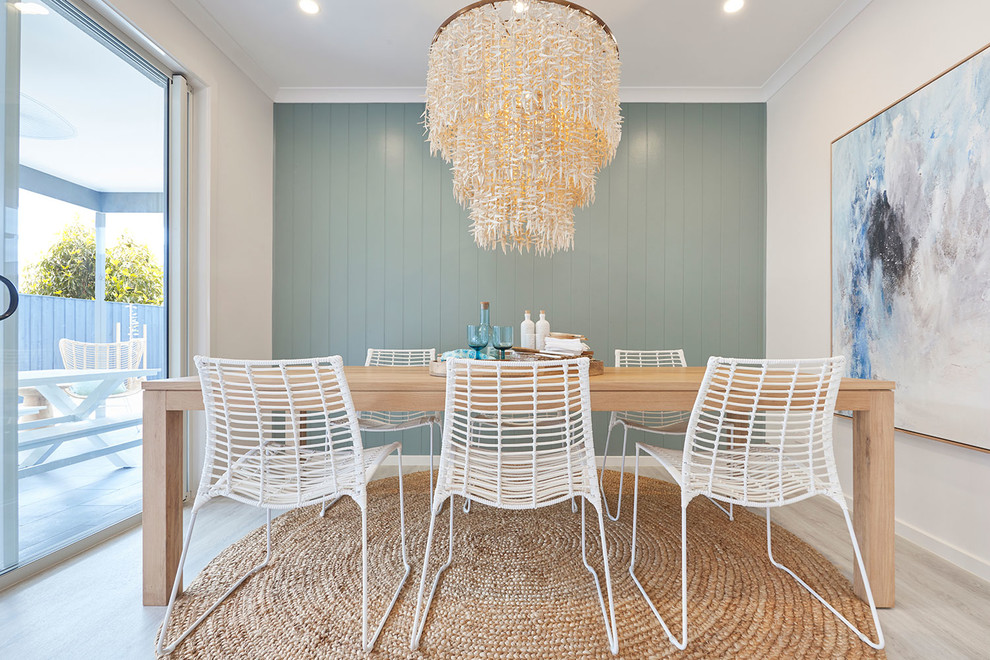Inspiration for a beach style separate dining room in Melbourne with white walls, light hardwood floors and grey floor.