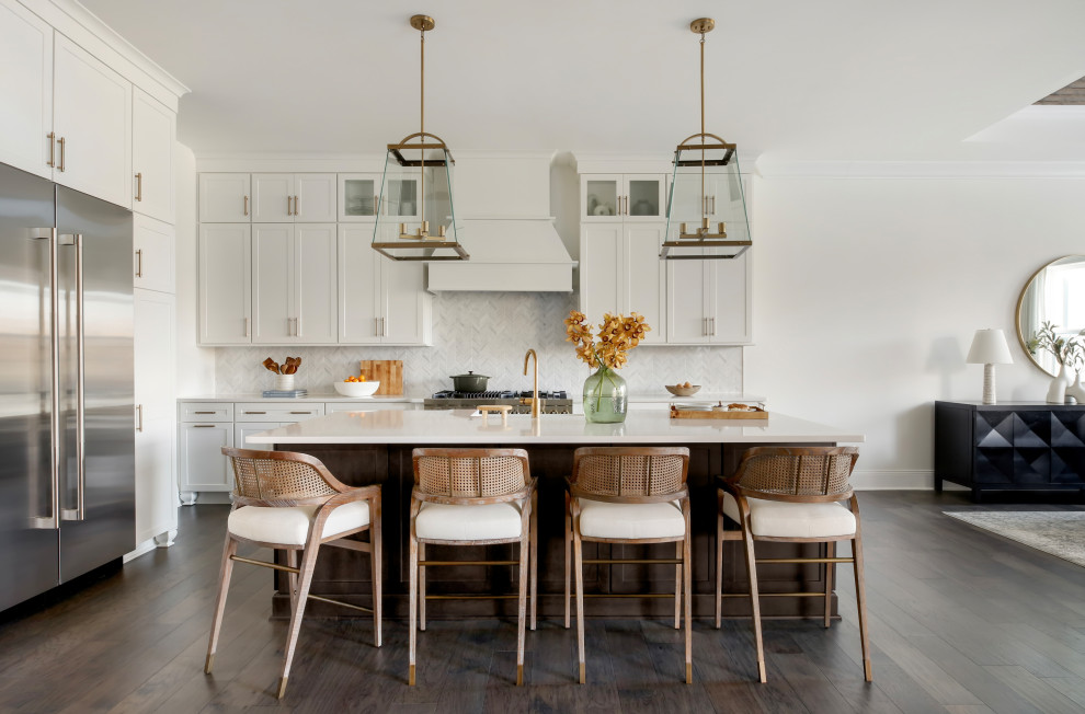 Inspiration for a mid-sized transitional dark wood floor and brown floor eat-in kitchen remodel in Nashville with white cabinets, marble countertops, white backsplash, ceramic backsplash, stainless steel appliances, an island and white countertops