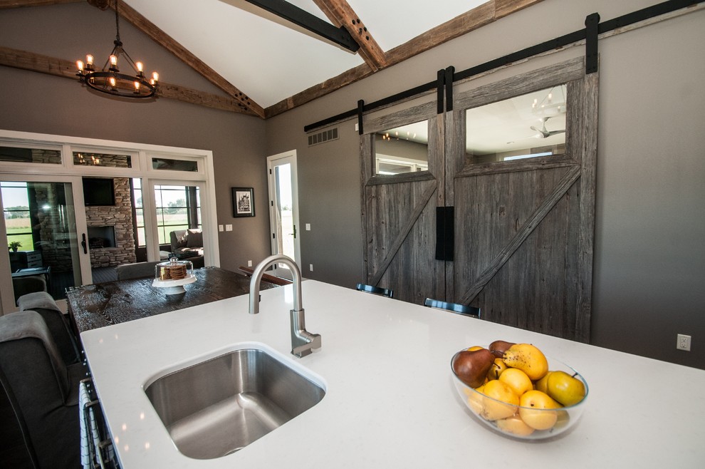 Inspiration for a large rustic dark wood floor and brown floor eat-in kitchen remodel with an undermount sink, flat-panel cabinets, medium tone wood cabinets, quartz countertops, green backsplash, glass sheet backsplash, stainless steel appliances and an island