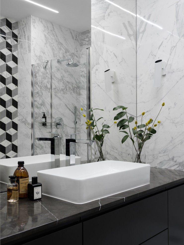 Inspiration for a small contemporary 3/4 bathroom in Moscow with flat-panel cabinets, grey cabinets, an alcove shower, a wall-mount toilet, white tile, porcelain tile, white walls, a drop-in sink, marble benchtops, a hinged shower door, black benchtops, a single vanity and a floating vanity.