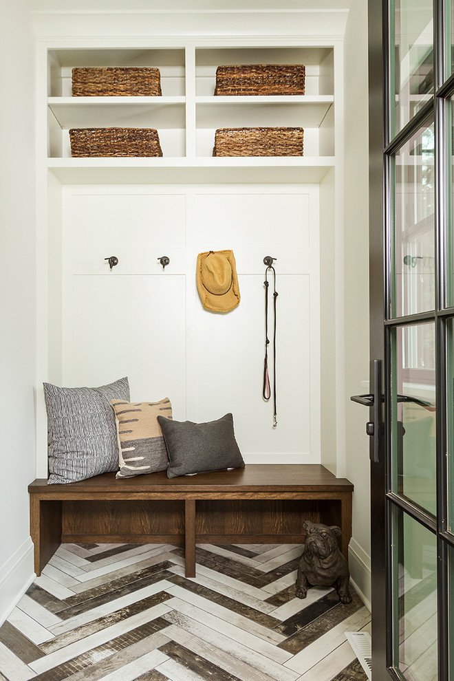 This is an example of a mid-sized transitional mudroom in Minneapolis with white walls, porcelain floors, a single front door, a glass front door and multi-coloured floor.