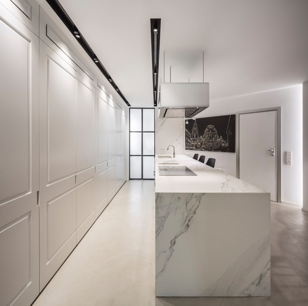 Design ideas for a large contemporary single-wall separate kitchen in Valencia with an undermount sink, panelled appliances, concrete floors, with island, grey floor and white benchtop.