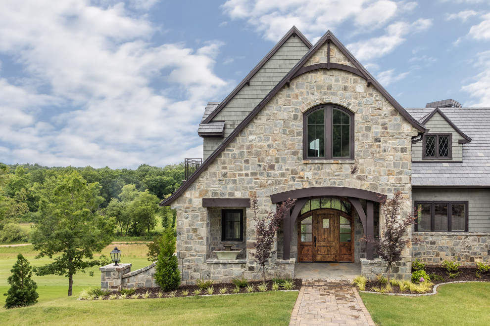 Inspiration for a large transitional gray three-story stone and shingle gable roof remodel with a tile roof and a gray roof