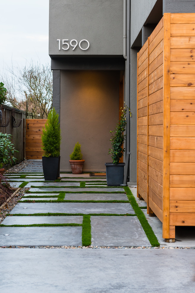 Example of a mid-sized trendy concrete floor and gray floor front door design in Vancouver with gray walls and a medium wood front door