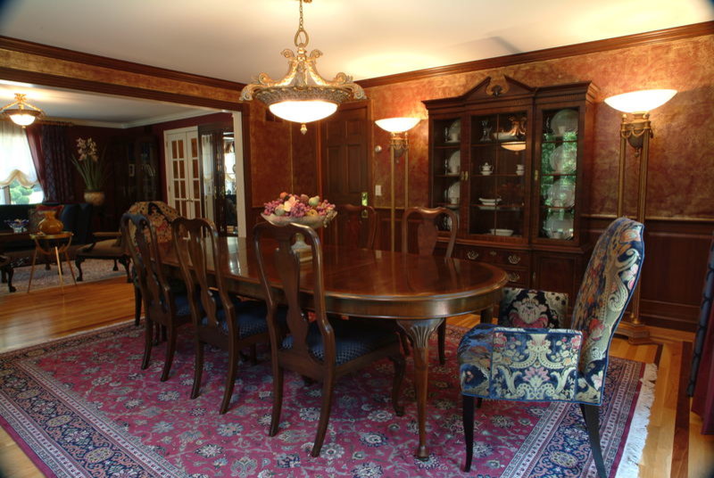 Inspiration for a large medium tone wood floor dining room remodel with red walls