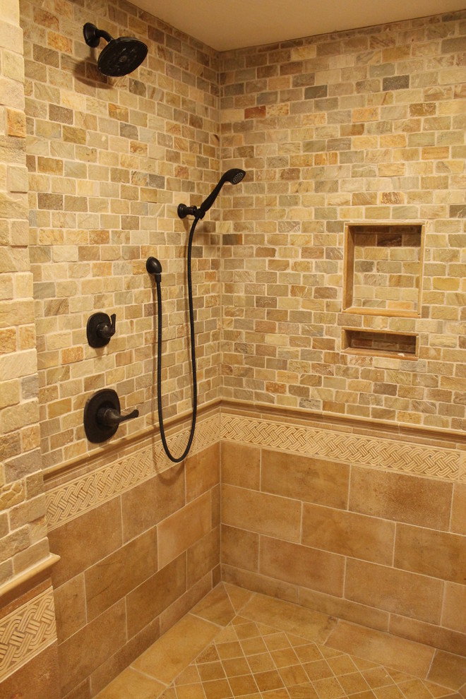 This is an example of a traditional master bathroom in Other with an open shower, multi-coloured tile, stone tile and limestone floors.