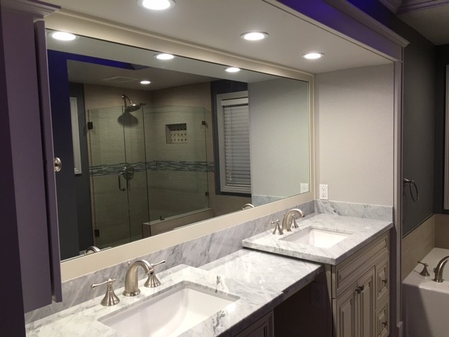 Tub/shower combo - mid-sized transitional master tub/shower combo idea in Orange County with raised-panel cabinets, gray cabinets, beige walls, an undermount sink and marble countertops
