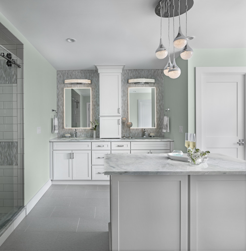 Freestanding bathtub - transitional master green tile and glass tile marble floor and gray floor freestanding bathtub idea with shaker cabinets, white cabinets, green walls, an undermount sink, marble countertops and gray countertops