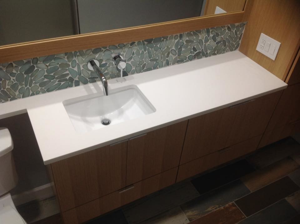 Example of a mid-sized transitional 3/4 gray tile and pebble tile medium tone wood floor bathroom design in Indianapolis with flat-panel cabinets, medium tone wood cabinets, gray walls, an undermount sink and quartzite countertops